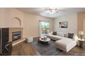 Bright living room features a stone fireplace and access to the outdoor balcony at 8737 Red Brook Dr # 204, Las Vegas, NV 89128