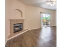 Spacious living room featuring a fireplace and balcony access for seamless indoor-outdoor living at 8737 Red Brook Dr # 204, Las Vegas, NV 89128