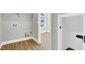 Utility room with a window and hook-ups, with views to a bedroom space at 9116 Vista Greens Way # 104, Las Vegas, NV 89134