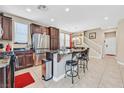 Modern kitchen featuring a breakfast bar, stainless steel appliances, and bright, airy lighting at 9118 Mount Wilson St, Las Vegas, NV 89113