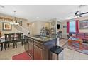 Open-concept kitchen featuring an island with granite countertops that flows into the living area at 9118 Mount Wilson St, Las Vegas, NV 89113