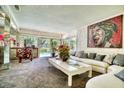 Bright living room featuring a large sofa, unique artwork, and sliding glass doors to the outdoor pool area at 940 Vegas Valley Dr, Las Vegas, NV 89109
