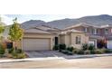Attractive single-story home featuring desert landscaping, a tile roof, and an attached two-car garage at 9537 Wild Valley Ave, Las Vegas, NV 89148