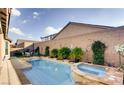 Backyard pool and spa are accented with manicured desert plants and a privacy wall at 9537 Wild Valley Ave, Las Vegas, NV 89148