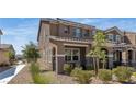 Side view of stucco-clad two-story home with desert landscaping and a walkway, under a blue sky at , Henderson, NV 89044