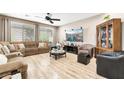 Spacious living room with laminate wood flooring, neutral walls, and recessed lighting at 10247 Jamapa Dr, Las Vegas, NV 89178