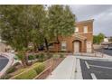 Well-maintained building exterior with manicured landscaping, visible unit numbers, and convenient parking at 10291 Delta View Ct # 101, Las Vegas, NV 89129