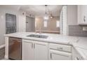 Kitchen boasts stainless steel appliances, gray backsplash and a quartz countertop at 10291 Delta View Ct # 101, Las Vegas, NV 89129