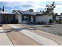 Inviting single-story house with solar panels, a spacious driveway, and a covered parking area at 109 Ash St, Henderson, NV 89015