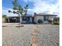 Single-story home with solar panels, well-kept landscaping, and a stone walkway at 109 Ash St, Henderson, NV 89015