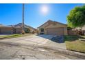 Attractive single-story home with desert landscaping and a large driveway leading to a two-car garage at 1441 Palm Dr, Laughlin, NV 89029