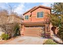 Charming two-story home featuring desert landscaping, a two-car garage, and a welcoming front entrance at 1512 Groom Ave, North Las Vegas, NV 89081