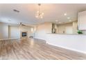 Spacious living area with wood-look flooring, modern lighting, and easy access to the kitchen at 1512 Groom Ave, North Las Vegas, NV 89081