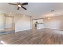 Bright and airy living room features wood-look flooring and an open floor plan to the kitchen and dining area at 1512 Groom Ave, North Las Vegas, NV 89081