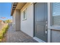 Inviting entryway showcasing a gray front door with brick walkway, complemented by stylish exterior finishes at 157 Sarabeth St, Las Vegas, NV 89138