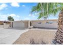 Inviting single-story house with a neat front yard, featuring mature landscaping and a driveway at 1628 Patricia St, North Las Vegas, NV 89030