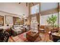 Bright living room with high ceilings, neutral paint, large windows and cozy seating at 1721 Derbyshire Dr, Las Vegas, NV 89117