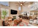 Spacious living room with high ceilings, a fireplace, and seamless flow to the dining area at 1721 Derbyshire Dr, Las Vegas, NV 89117