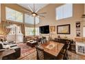 Open-concept living area featuring vaulted ceilings, natural light, and stylish furnishings at 1721 Derbyshire Dr, Las Vegas, NV 89117