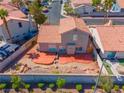 Aerial view of the backyard featuring a red concrete patio, rock landscaping, and privacy wall at 2080 Silver Breeze Ave, Las Vegas, NV 89183