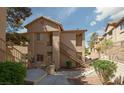 Apartment building exterior with stairs and desert landscaping at 2110 Los Feliz St # 1034, Las Vegas, NV 89156