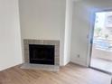 Living room with a fireplace, wood floors and sliding door to the outside at 2160 Highpointe Dr # 102, Laughlin, NV 89029