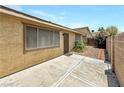 Backyard featuring concrete patio, stucco exterior, and desert-friendly landscaping at 2204 Short Pine Dr, Las Vegas, NV 89108