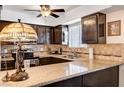 An efficient kitchen shows dark wood cabinets, granite countertops, and stainless steel appliances at 2725 S Nellis Blvd # 1037, Las Vegas, NV 89121