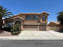 Beautiful two-story home with a three-car garage, complemented by mature trees and manicured landscaping at 2728 Aspen Wood Ave, Henderson, NV 89074