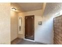 Inviting entryway with dark wood door, decorative tile, and neutral walls at 2845 Queens Courtyard Dr, Las Vegas, NV 89109
