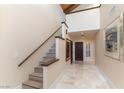 Bright foyer with stairway, tiled floor, and elegant artwork on display at 2845 Queens Courtyard Dr, Las Vegas, NV 89109