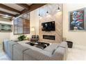 Stunning living room featuring a modern fireplace, wood beams, and stylish decor at 2845 Queens Courtyard Dr, Las Vegas, NV 89109