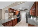 Kitchen features granite countertops, stainless steel appliances, tile backsplash, and wood cabinets at 2995 E Sunset Rd # 134, Las Vegas, NV 89120
