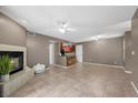 Spacious living room with tile flooring, fire place, neutral colored walls, and open view to the kitchen at 2995 E Sunset Rd # 134, Las Vegas, NV 89120