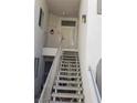 Exterior stairway leading up to units with secure entry doors and railings at 3125 N Buffalo Dr # 2104, Las Vegas, NV 89128