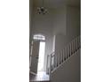 Spacious entryway features stairs, tile flooring, and a decorative light fixture at 3644 Starlight Evening St, Las Vegas, NV 89129