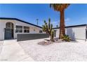 Stylish home with xeriscaped landscaping featuring stone accents and palm trees at 3647 Ottawa Cir, Las Vegas, NV 89169