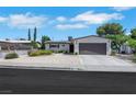 Single-story home showcasing a two-car garage, low-maintenance front yard, and classic design at 415 Emerald Cir, Henderson, NV 89002