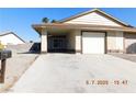 Inviting exterior featuring a covered parking area, one-car garage, and well-maintained front yard at 4382 Pinegrove St, Las Vegas, NV 89147
