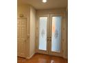 Bright foyer featuring decorative glass double doors and gleaming hardwood floors at 5049 Alfingo St, Las Vegas, NV 89135