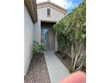 Welcoming walkway leading to a charming front door, framed by lush greenery at 5049 Alfingo St, Las Vegas, NV 89135