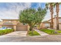 Well maintained home with mature landscaping, driveway, and a two-car garage at 508 Tara Ct, Boulder City, NV 89005