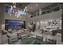 Open-concept living space with soaring ceilings, city views, and a gourmet kitchen with sleek countertops at 523 Overlook Rim Dr, Henderson, NV 89012