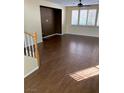 Bright living room with beautiful wood floors, a ceiling fan, and natural light streaming through plantation shutters at 533 Via Santiago St, Las Vegas, NV 89144
