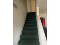 Carpeted staircase with a built-in storage cabinet, leading to the upper level of the home at 5417 Seabaugh Ave, Las Vegas, NV 89107