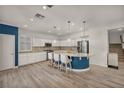 Modern kitchen features an island with seating, white cabinets and stainless steel appliances at 5553 Coral Gate St, Las Vegas, NV 89148