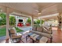 Covered patio with comfortable seating and a view of the backyard entertainment area at 5553 Coral Gate St, Las Vegas, NV 89148