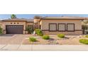 Single-story home featuring desert landscaping, brick accents, and a two-car garage at 5576 Buena Martina Way, Las Vegas, NV 89141