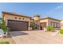 Beautiful single-story home with a three-car garage, desert landscaping, and a turret entry at 5576 Buena Martina Way, Las Vegas, NV 89141
