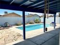 Backyard pool with a covered patio and rock landscaping at 6309 Miraloma St, Las Vegas, NV 89108